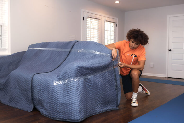 Zip Moving and Storage packing couch.